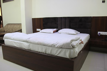 Family suite with seating area at New Hotel Sanskar